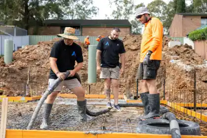 Construction workers pouring concrete on site | Charleston Concrete