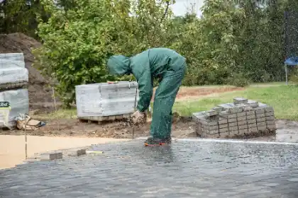 Paving being laid by worker in protective gear | Charleston Concrete