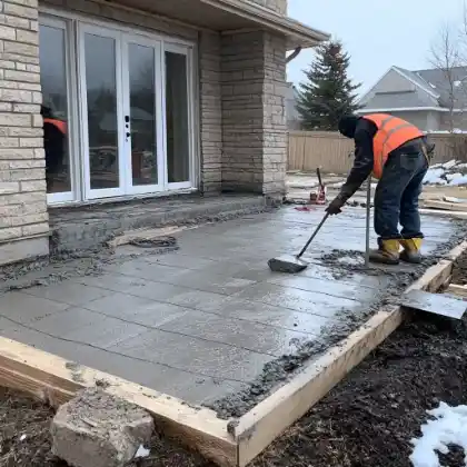 Worker working on concrete patio | Charleston Concrete